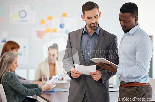 Image of Consulting mentor, business men with a tablet and office employees work on creative design, digital marketing and advertising strategy. Corporate leadership, brainstorming meeting and a startup team