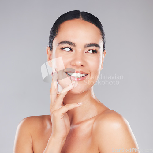 Image of Beauty, skincare and woman in a studio for wellness, health and natural face or skin routine. Happy, smile and girl model from Asia with a cosmetic facial treatment isolated by a gray background.