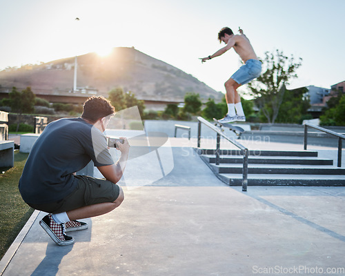 Image of Skateboard jump outdoor, photographer in park for extreme sports photoshoot with skater in summer. Skatepark photo session, man grind rail and sport for fitness, stunt and training in Cape Town