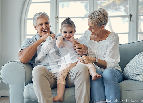 Image of Family, grandmother and grandfather with girl on sofa, having fun and bonding. Portrait, love and care of happy grandparents with kid or child on couch in living room enjoying quality time together.