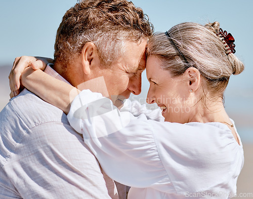 Image of Love, romance and beach with a senior couple hugging outdoor in nature while enjoying a retirement vacation. Travel, summer and together with a mature man and woman pensioner bonding on the coast