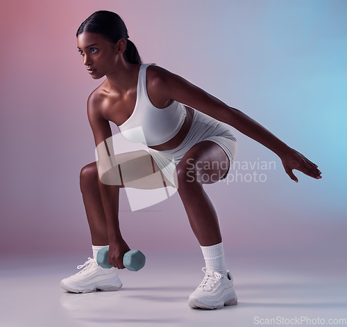 Image of Fitness, dumbbell and girl in studio training, exercise and workout for strong powerful arms and muscles. Wellness, healthy and young Indian woman lifting dumbbells exercising full body with energy