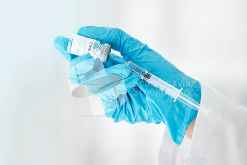 Image of Covid, vaccine and medicine with hands of doctor and syringe for medical, science or pharmacy. Research, innovation or healthcare injection for nurse and prevention drug for flu, disease or treatment