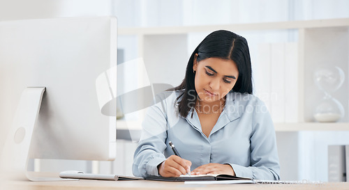 Image of Business woman writing notes, schedule and planning ideas, meeting administration and research in notebook at office desk. Employee, receptionist and strategy reminder, calendar or agenda information