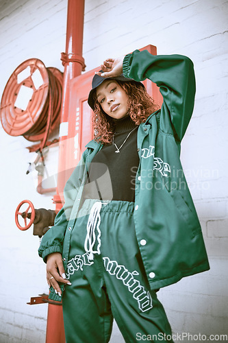 Image of Fashion, wall and black woman with green clothes, fashionable style or cool hip hop outfit. Fire hose, attitude or portrait of gen z girl with trendy streetwear, designer brand or 2000s rap aesthetic