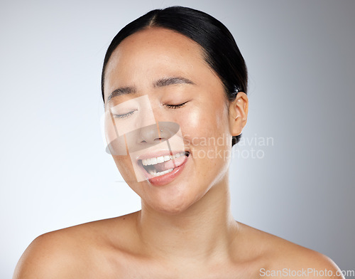 Image of Woman face, tongue out and beauty skincare natural makeup glow. Young happy Asian girl, funny face eyes closed and healthy facial or body cosmetics for advertisement in grey studio background