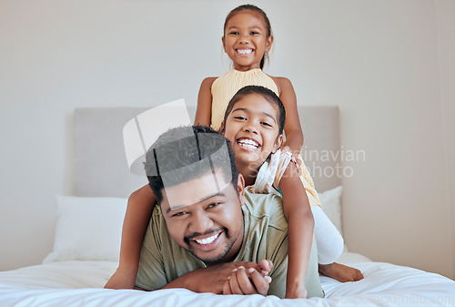 Image of Family, children and bed with a man, daughter and sister having fun together in their home while bonding. Bedroom, love and playful with a father and daughter siblings laughing or joking in a house