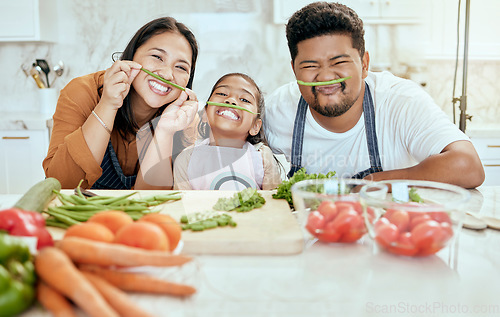 Image of Cooking, family and comic portrait in kitchen for crazy, goofy and silly fun together with smile. Food, asian and bonding with funny vegetable face of happy mother, father and child in house.