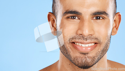 Image of Skincare, portrait and man in studio for beauty, teeth and wellness against a blue background mockup. Face, cleaning and skin by model happy, smile and relax during grooming, hygiene and body care