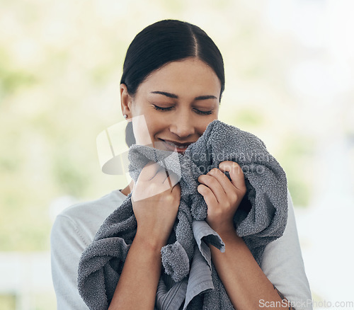Image of Laundry, fresh and woman smelling clean clothes with a smile, peace and calm in a house. Happy, young and smiling cleaner cleaning clothing, linen and towel in the morning with happiness in a home