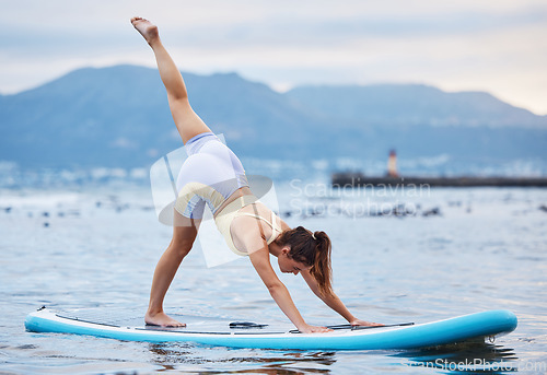 Image of Woman, surfboard or water yoga on ocean or sea in relax workout, training or exercise for core balance, health or wellness. Zen, calm or peace person on paddle board in nature fitness or body pilates