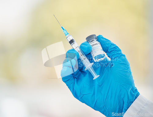 Image of Covid vaccine, bottle and needle in hand for medical innovation, safety and compliance in hospital, clinic or laboratory. Covid 19 vaccination doctor or pharmacist for corona virus healthcare mock up