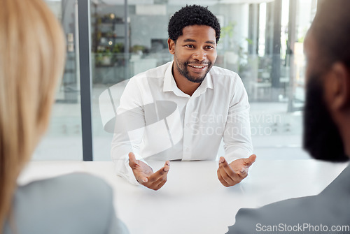 Image of Black businessman, meeting or job interview in office boardroom with human resources, recruitment or corporate hiring managers. Talking worker, employee or hr candidate with happy smile or motivation