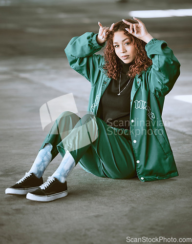 Image of Fashion, style and devil horns with a model black woman making a hand gesture outdoor in the city. Portrait, trendy and edgy with an attractive young female posing to promote contemporary clothes