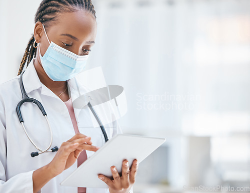 Image of Doctor, tablet and covid in healthcare research, browsing or scheduling appointment at the hospital. African American medical professional woman or GP checking, test or cure for virus on touchscreen