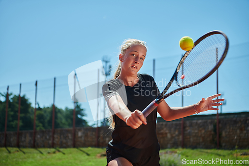 Image of A young girl showing professional tennis skills in a competitive match on a sunny day, surrounded by the modern aesthetics of a tennis court.