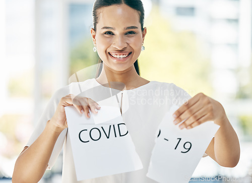 Image of Covid, sign and business woman at the end of the pandemic, happy and smile for freedom from virus at work. Excited, portrait and corporate employee tearing paper for free from corona in an office