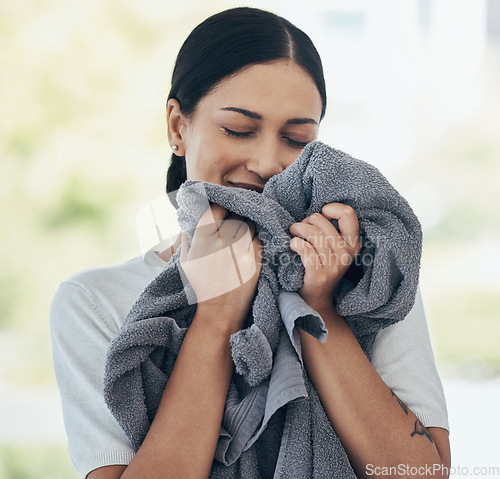Image of Clean laundry, happy woman and smelling towel, fresh scent and fabric, washing and linen textile at home. Young smile person, housekeeping service and domestic cleaning lifestyle