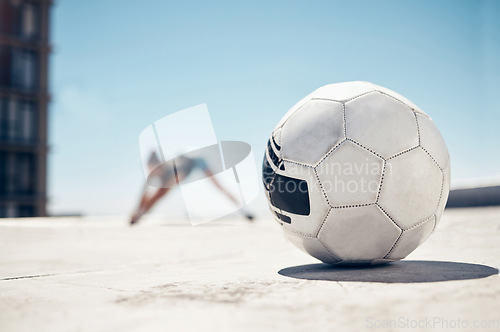 Image of Soccer ball, sport and fitness, training and exercise, sports workout and athlete stretching, prepare for football outdoor in urban town. Soccer, healthy and active lifestyle, cardio and endurance.