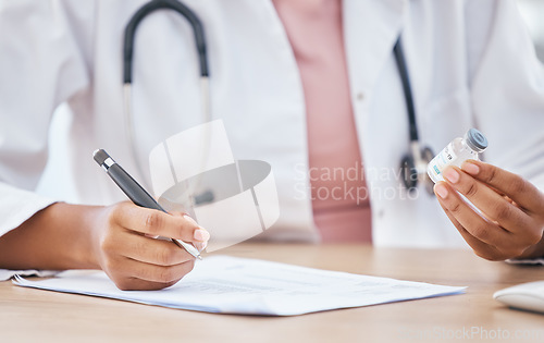 Image of Healthcare, hands and doctor writing with covid vaccine in office for medical, compliance and medicine. Hand, documents and woman doctor with corona cure at a desk, notes and pharmacy prescription