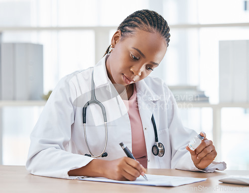 Image of Medicine, vaccine and doctor writing notes in her office while while preparing a vial for a patient, Healthcare, vaccination syringe and black woman doing inspection on a medical product in hospital.