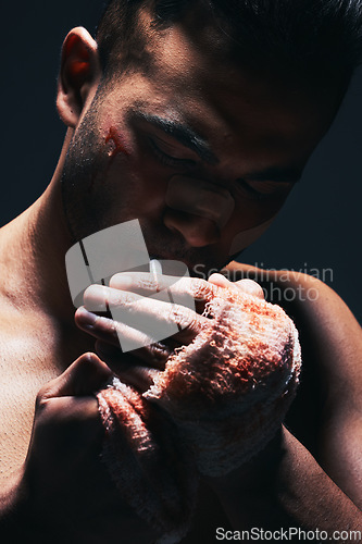 Image of Fighter, boxer blood and man smoking a cigarette after a exercise fight, match and training. Smoke of a hurt fighting athlete with a bleeding hand injury and workout medical accident from boxing