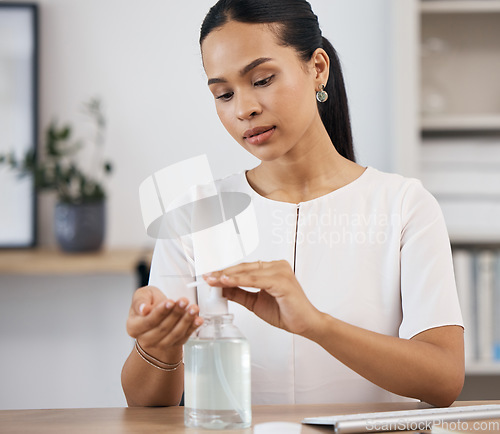 Image of Business woman sanitizing her hands in an office for hygiene, stop germs and protection. Hand sanitizer, clean and corporate employee from Mexico with coronavirus safety compliance in the workplace.