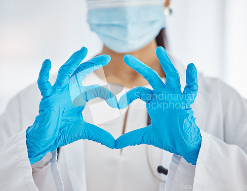 Image of Doctor, hands and heart sign for covid healthcare, love or trust for health and safety at the hospital. Hand of female nurse showing hearty emoji, icon or gesture in medical protection at the clinic