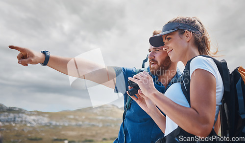 Image of Pointing, travel and couple hiking on the mountains in a natural environment for an outdoors adventure in Canada. Freedom, lifestyle and healthy woman loves walking or trekking with partner in nature