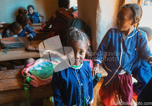 Image of Happy Malagasy school children students in classroom. School attendance is compulsory, but many children do not go to school.