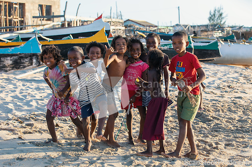 Image of Group of Malagasy children frolicking on the beach near the fishing village of Anakao.