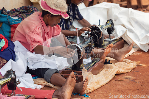 Image of Street tailors work with their outdated manual sewing machines. Earn some money in Madagascar is very difficult