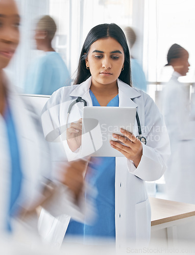 Image of Doctor, tablet and busy hospital with internet research, online schedule and digital calendar at work. Medical worker working in healthcare clinic planning with digital tech to check patient records