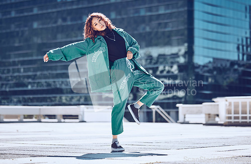 Image of City, dance and dancing woman on a rooftop with cool hip hop street fashion and creative artistic freedom. Balance, moving and young girl dancer in training, cardio workout and body exercise outdoors