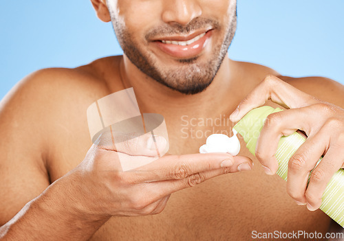 Image of Hand, shaving cream and man in studio for skincare, beauty and hair care against a blue background with mockup. Hands, foam and face hair grooming with model cleaning, hygiene and skin care product