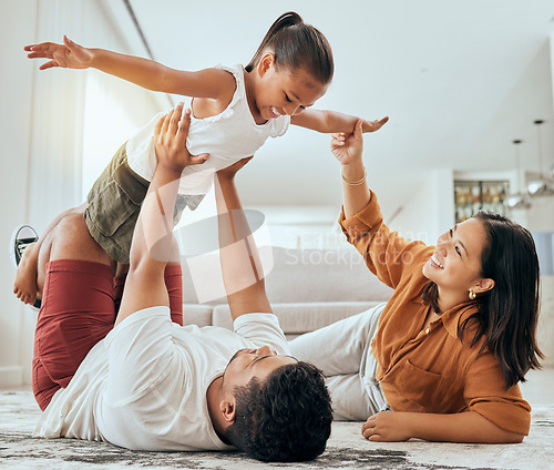 Image of Love, floor and fun happy family play, bond and enjoy quality time together while excited and relax on ground carpet. Happiness, care and childhood relationship of mom, dad and kid girl playing games