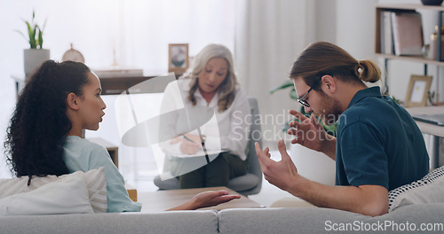 Image of Stress, divorce and couple in counseling with psychologist listening to fighting, marriage problems and conflict. Psychology, trouble and therapist helping a young woman and angry partner in therapy