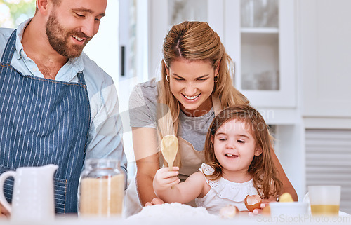 Image of Cooking, family and bakery food in kitchen with child learning, helping and happy with smile. Family home, mother and dad teaching young kid baking flour recipe for cake, cookies or pancakes.