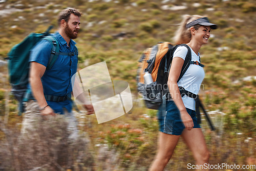 Image of Hiking, blurred motion and adventure with a couple in the mountain for health, exercise or fitness together. Nature, training and love with a man and woman walking in the mountains while bonding