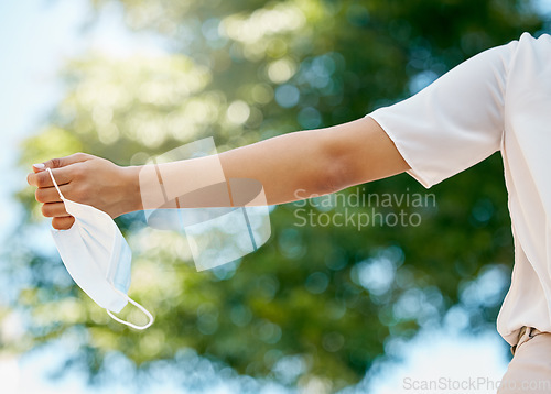 Image of Freedom, covid and hands with face mask in air at end of pandemic, lockdown and quarantine. Fresh air, happiness and carefree woman holding mask enjoying normal lifestyle in park, outdoors and nature