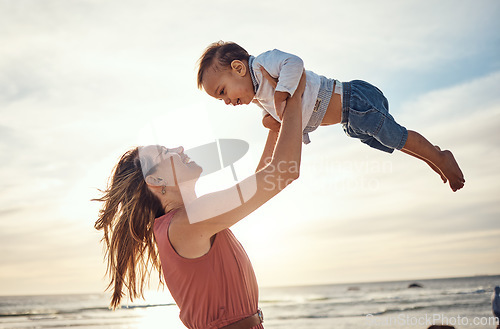 Image of Family, beach and sunset vacation with mother and lifting child in air for fun, love and care with support. Woman and baby happy about bonding experience while on holiday in Bali for summer travel