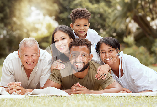 Image of Black family, happy lying portrait on lawn blanket and summer sunshine in garden together on grass. Mom dad, child grandparents and outdoor happiness, relax on holiday vacation and love bonding time