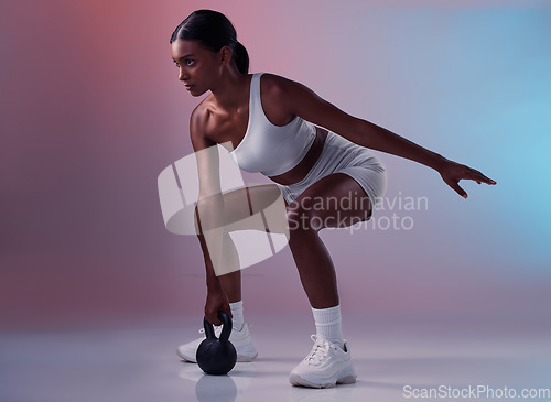 Image of Fitness, kettlebell and woman training in studio for full body balance, powerful muscles and strong arms. Sports, exercise and healthy Indian girl swinging weights or weightlifting in a squat pose