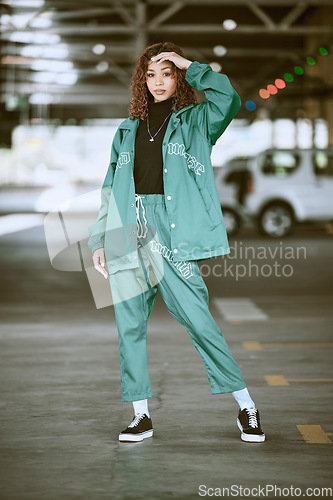 Image of Urban, fashion and girl portrait at parking lot in New York with edgy athleisure style. Gen Z, trendy and statement clothes of young city woman with assertive, confident and cool pose.