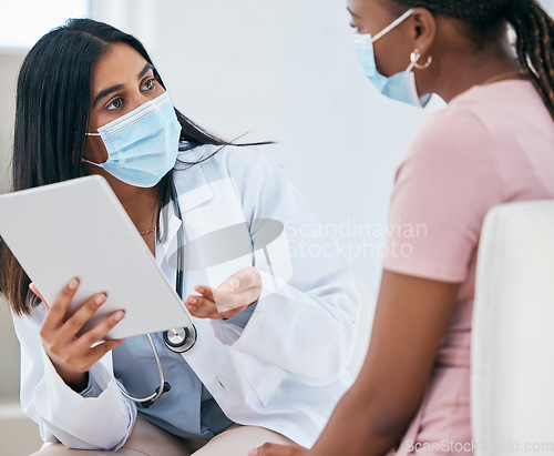Image of Black woman covid, doctor tablet results and talking in hospital office for healthcare report discussion. Woman digital medic, corona technology for diagnosis and medical conversation for clinic help