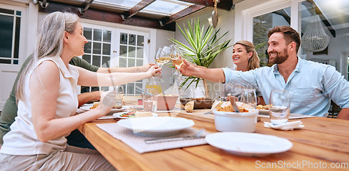 Image of Friends, wine and celebration toast with family to celebrate holiday with lunch party, food and wine at patio table. Men and women couple drinking alcohol together and happy while talking home