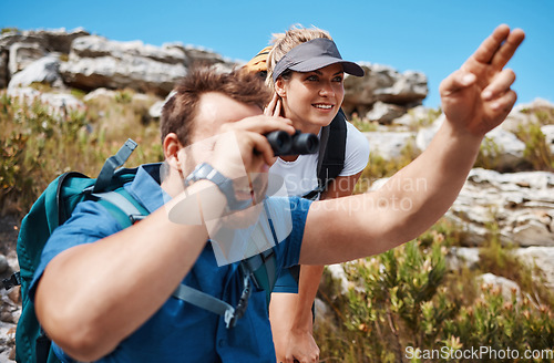 Image of Couple, binocular and hiking in mountain and enjoy view, exercise and fitness in nature while trekking. Freedom, rock and woman with ma, backpack and training for health and wellness outdoor travel