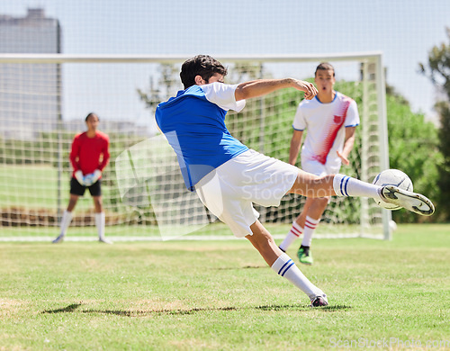 Image of Sports, soccer and athlete scoring a goal during a match or training on an outdoor pitch at a stadium. Football, fitness and healthy man practicing to score at a game for exercise or workout on field