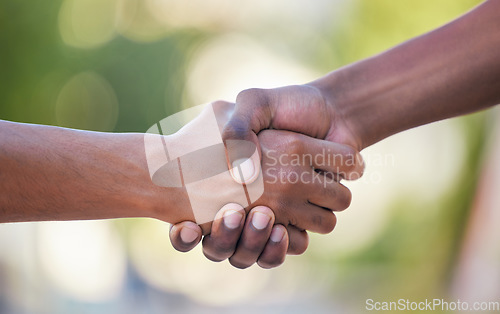 Image of Hands, handshake and friendship in trust, support or care for relationship, agreement or unity against bokeh background. Hand of people shaking for community, collaboration or partnership deal