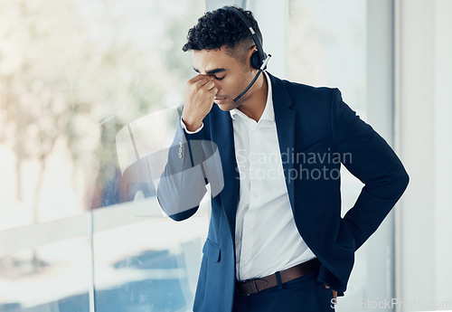 Image of Businessman, headache and call center in burnout, stress or depression for consulting or telemarketing at the office. Man in contact us, customer service or support suffering with mental health issue